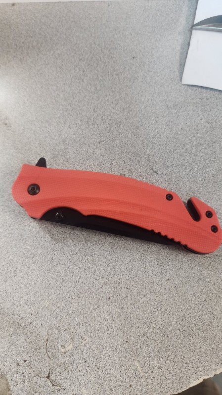 Orange-handled folding rescue knife with a seatbelt cutter and glass-breaker tip