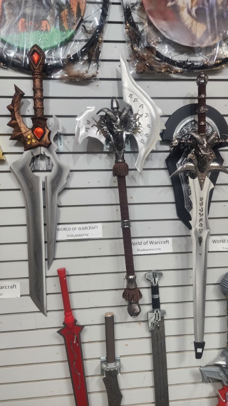 World of Warcraft replica blades &mdash; Shalamayne, Shadowmourne and Frostmourne &mdash; mounted on a slatwall